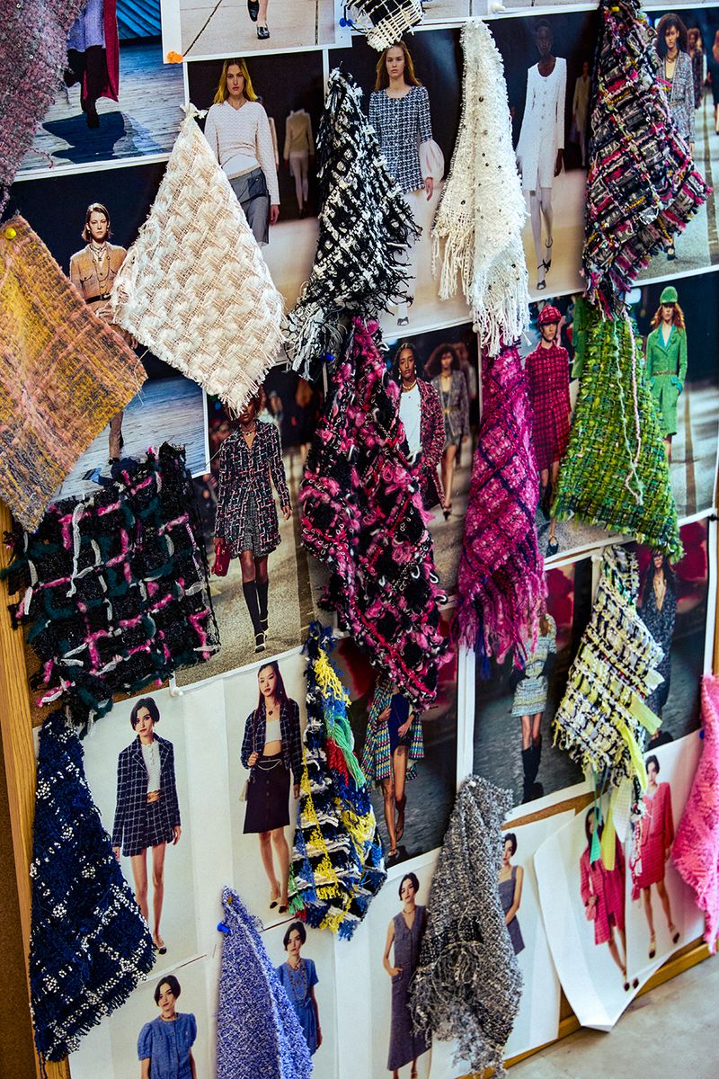 Fashion presentation featuring swatches of colorful tweed fabric pinned to a board with fashion design concept images attached.