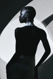Portrait silhouette of a Black woman with braided hair against a patterned white light background
