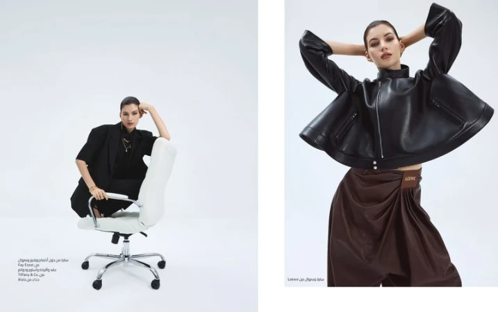 Fashion editorial shot of a woman in stylish black and brown outfits, sitting on a chair in a studio against a bright white background.