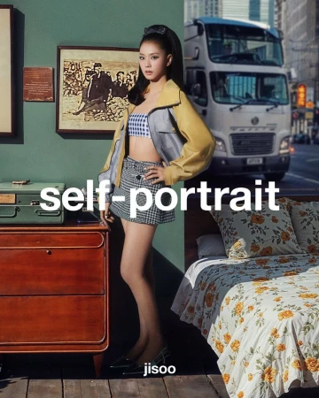 A young woman in stylish casual clothing strikes a pose, standing next to a dresser and bed, with a truck and city visible in the background.