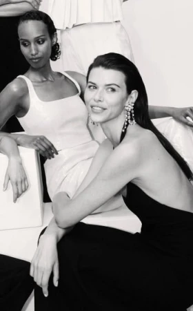 Monochrome fashion portrait featuring two female models posing in evening wear for Witchery