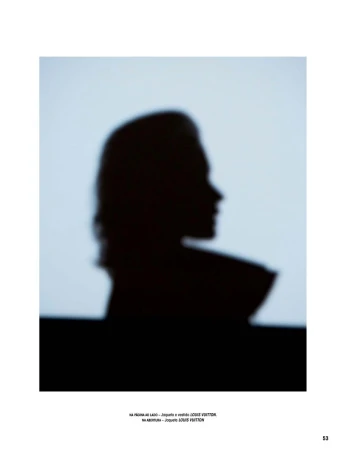 Silhouette of a woman in profile, against a light blue background, with text visible at the bottom of the image.
