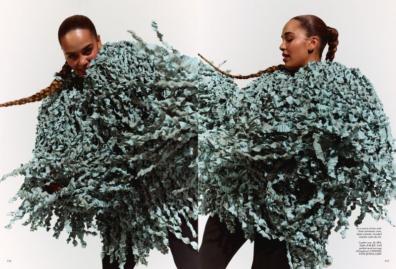 Editorial fashion shot featuring two adult females wearing textured blue clothing against a bright white studio backdrop with braids.