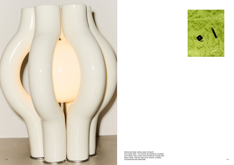 Sculptural white lamp with glowing bulb, set against a neutral backdrop. Abstract and modern lighting design.