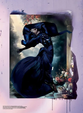 A woman in a blue gown strikes a pose within a framed artwork featuring a classical column and painted floral accents, under studio lighting.