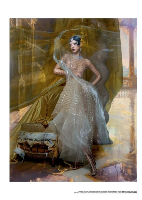 A fashion shot showcases a woman in an embellished dress, sheer veil, and jewelry against an abstract gold backdrop with a worn box prop.