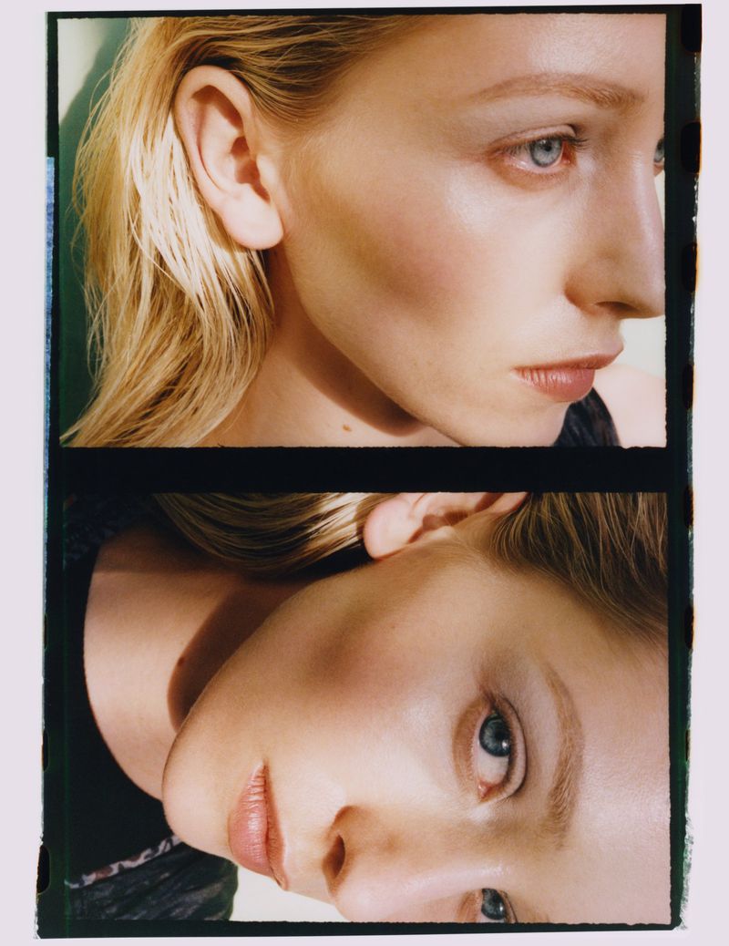 Close-up film portrait of a woman with blonde hair, blue eyes, and fair skin, split into two parts, against a light green backdrop.