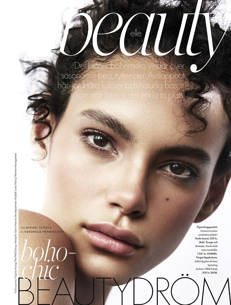 Beauty magazine cover featuring a close-up portrait of a woman with curly hair and natural makeup, with the magazine's title and text overlay.