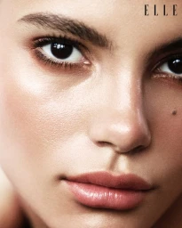 Close-up beauty portrait of a female model with natural makeup and glowing skin for Elle Sweden