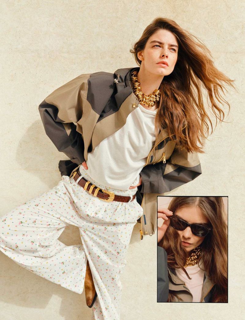 A woman poses in a patterned jacket, white shirt, floral pants, and brown boots with a beige backdrop and inset image.