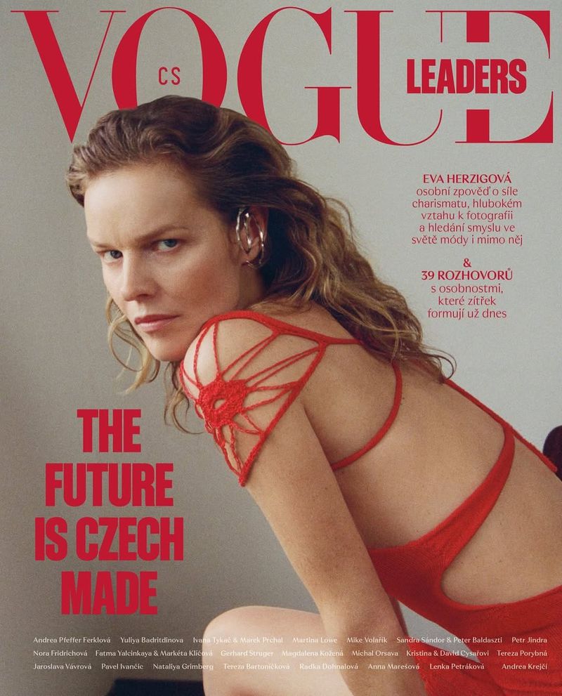 Eva Herzigova on the cover of Vogue CS Leaders issue, wearing a red dress with string details, set against a neutral backdrop.