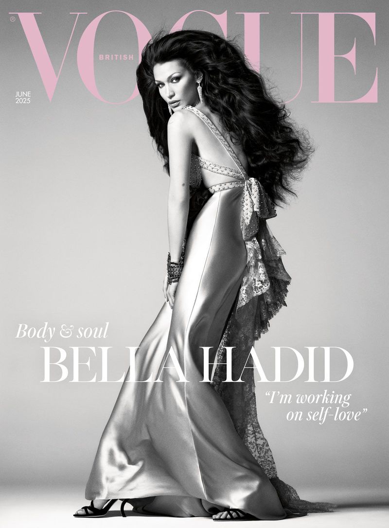 Vogue cover featuring Bella Hadid wearing a silver dress with lace detailing, posing against a gray background with the magazine's masthead.