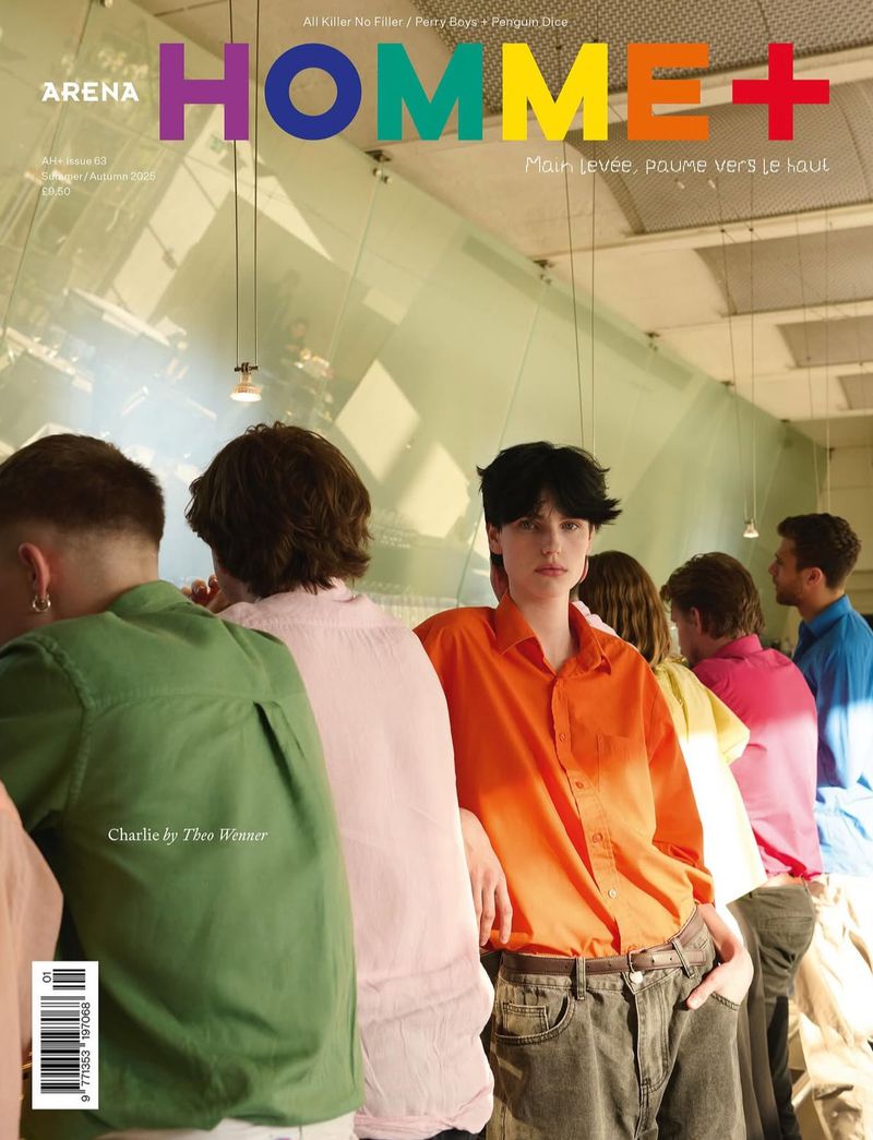 Magazine cover with a group of young adults in colorful shirts standing together against a glass wall; the magazine title is 'HOMME+'.
