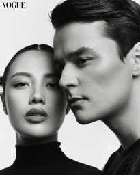 Black and white portrait of a man and a woman posing closely together against a white background for Vogue Philippines.