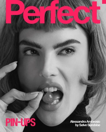 Black and white portrait of Alessandra Ambrosio on a magazine cover, holding cherry to her mouth, with pink text overlay.