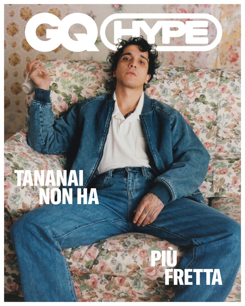 GQ Hype magazine cover featuring a young man with dark curly hair in a denim jacket and jeans, casually posed on a floral sofa.