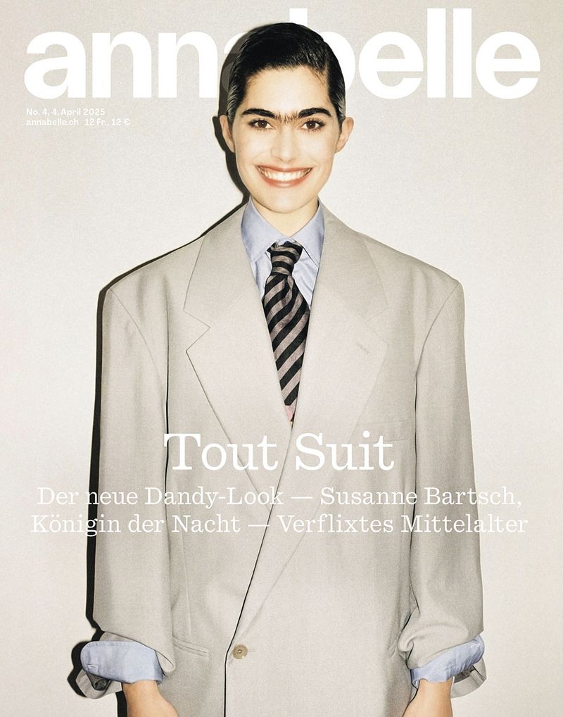 Magazine cover featuring a woman in an oversized grey suit, striped tie, and collared shirt. "annabelle" text is at the top.