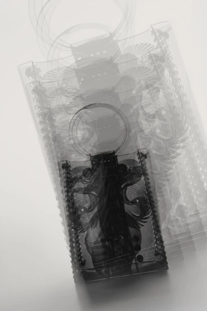 Ghosted effect of multiple semi-transparent tote bags overlapping. Black and white tones with an ornate dark rectangle design in the middle.