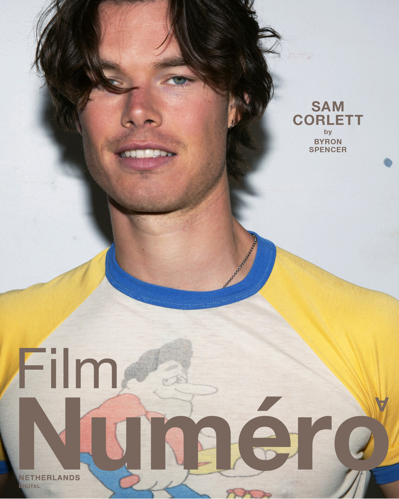 Close-up shot of Sam Corlett wearing a graphic tee shirt. The photo is for Numéro magazine, with logo and title visible on the shirt.