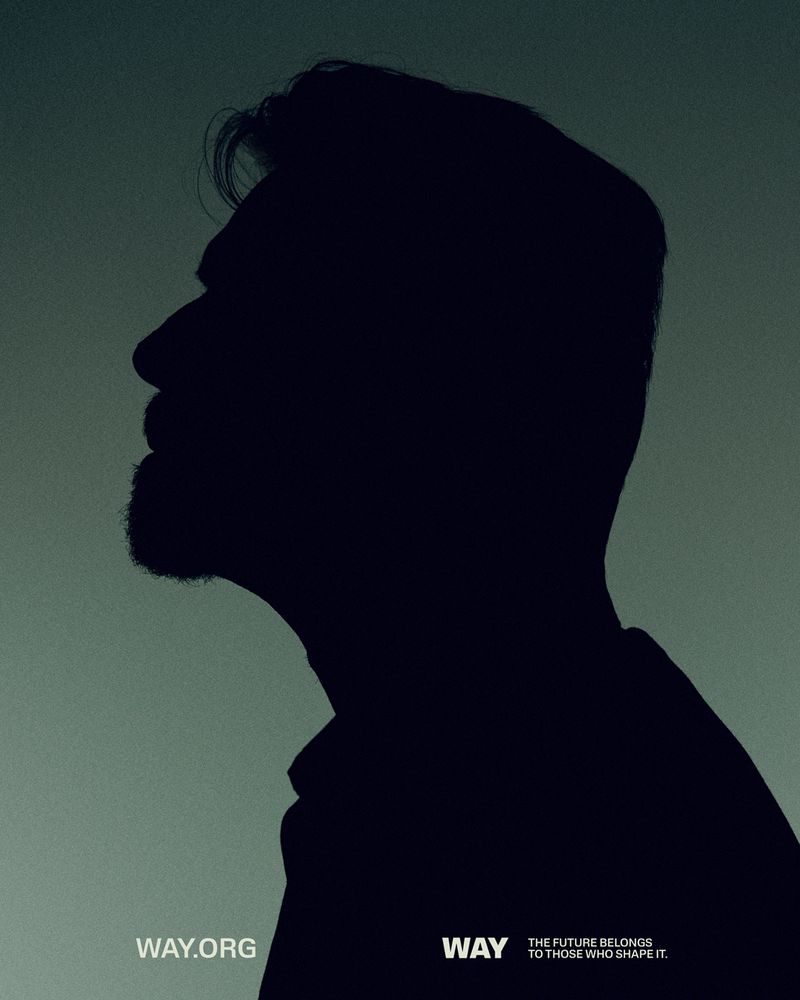 Silhouette of a dark-haired man in profile against a muted green background, evoking a sense of mystery and contemplation.