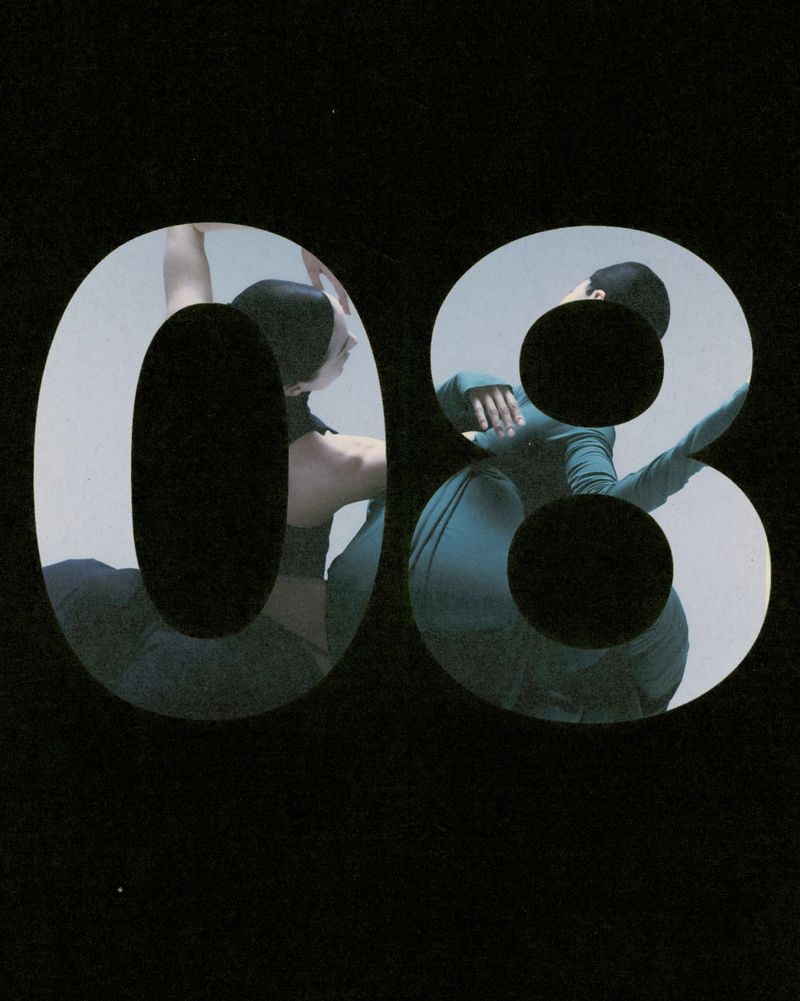 Abstract image of two dancers visible through cut-out numerals '08' against a black backdrop, showcasing movement and form.