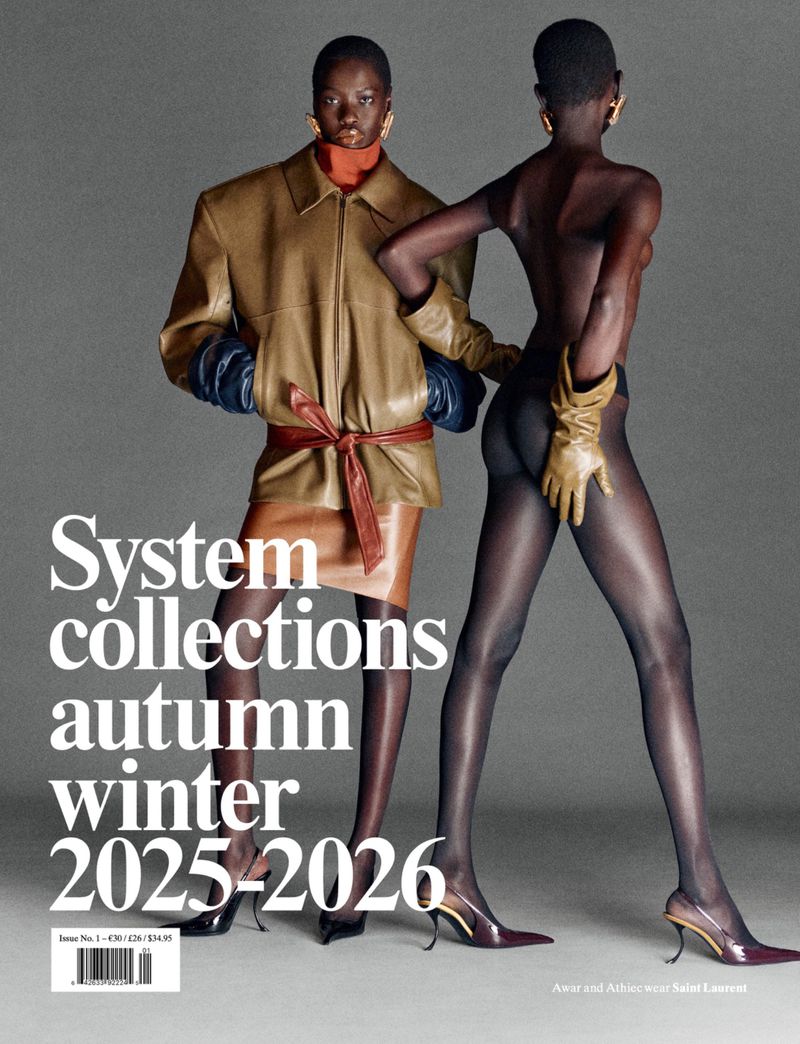 Fashion magazine cover featuring two Black female models in stylish clothing against a gray background; "System" and seasonal text visible.