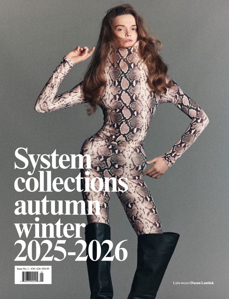 Fashion editorial featuring a woman in a snakeskin-print catsuit and black boots, posing against a gray background for System magazine.