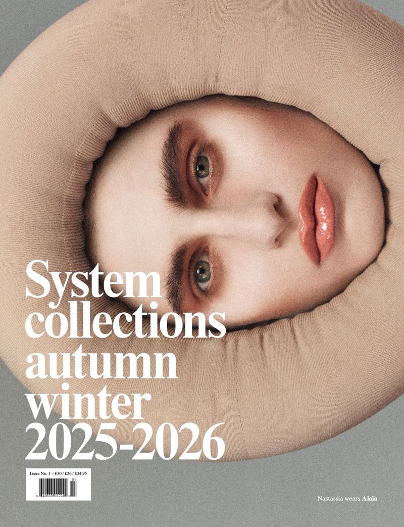 Magazine cover featuring a model with makeup, wearing a beige padded garment around her head and shoulders, with the magazine title visible.