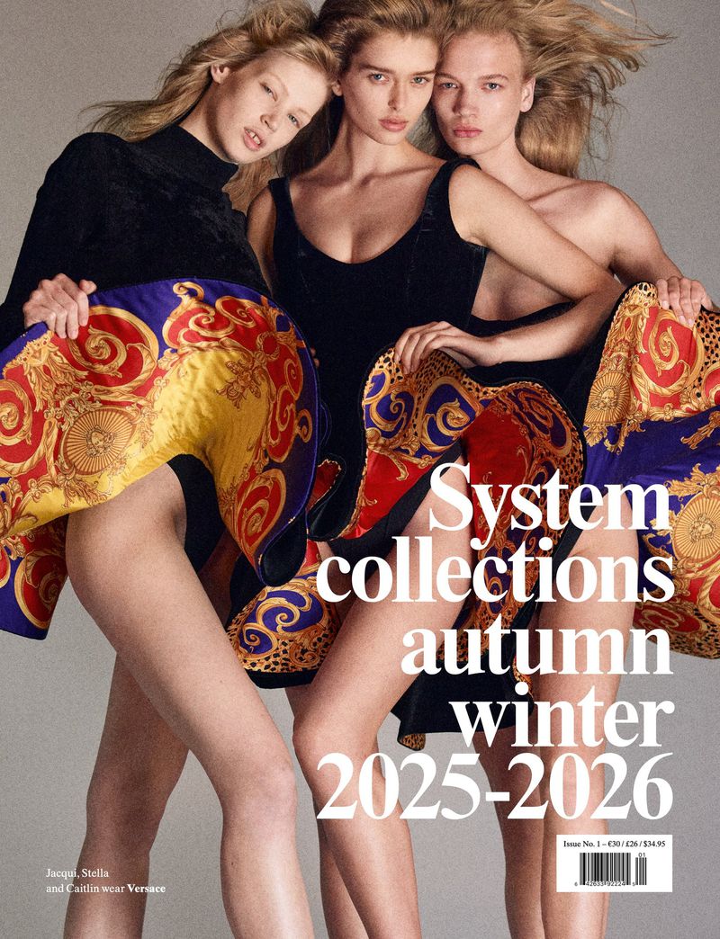 Editorial fashion shot featuring three fair-skinned fashion models in black dresses and patterned fabric wraps, set against a neutral backdrop.