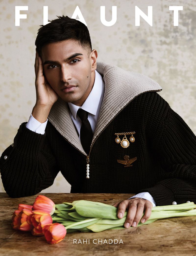 Flaunt magazine cover featuring Rahi Chadda, an adult male model, wearing a dark cardigan, a white shirt, and a dark tie, with tulips.