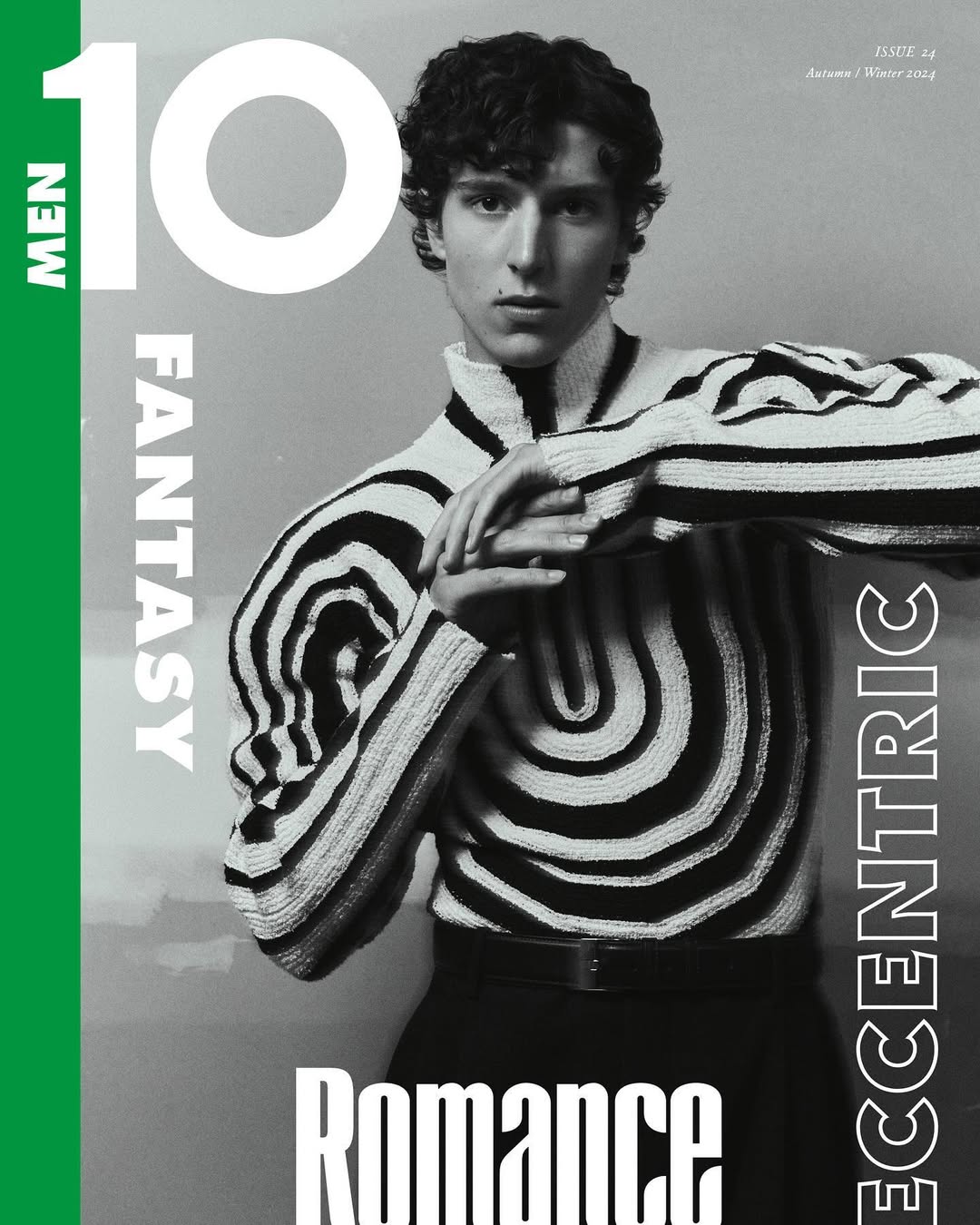 Magazine cover featuring a stylish young man with curly hair in a black and white patterned sweater and black pants.