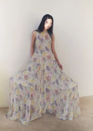 Model Chen Yang in a long floral printed dress standing against a plain neutral background for Beyond Noise project Chen.