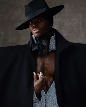 Model Alton Mason wearing a wide-brimmed black hat and structured black coat for BOSS at the Met Gala 2025.
