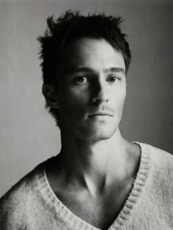 Portrait of actor Drew Starkey wearing a knitted sweater against a neutral background for Esquire Australia.