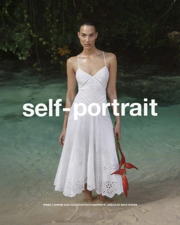 Fashion shot: Woman in white dress stands on sandy beach in ocean holding red flower, backed by green trees and 'self-portrait' text overlay.