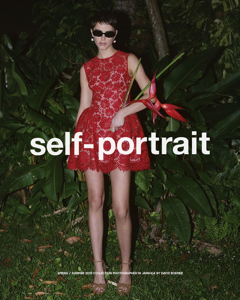 Fashion editorial featuring a woman in a red lace dress posing in a lush tropical setting with green foliage and a bird of paradise flower.