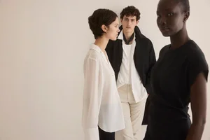 Three models posing against a plain neutral background for Club Monaco spring 2025 campaign