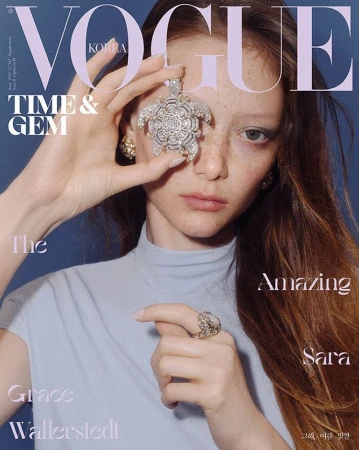 Vogue Korea cover featuring a woman with light skin and red hair. She is wearing jewelry and posing against a blue backdrop.