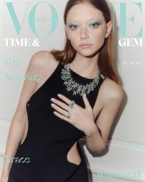 Model Sara Grace Wallerstedt wearing a diamond necklace and black dress against a plain wall for Vogue Korea June 2025.