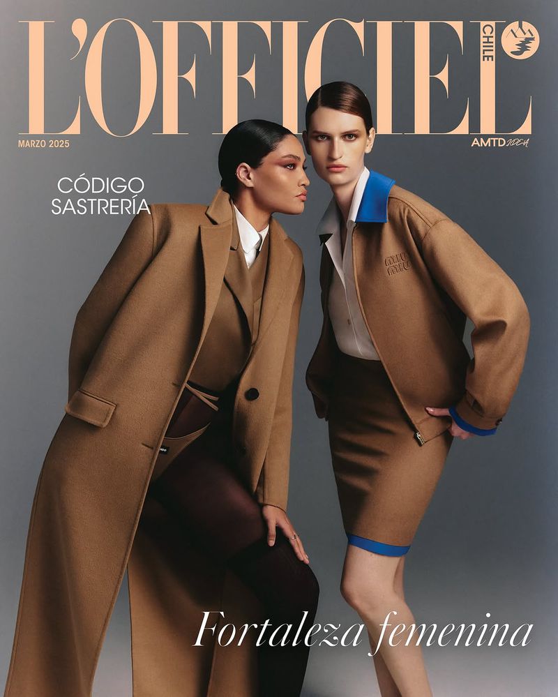Two women in stylish tan outfits on a fashion magazine cover; the one on the left wears a long coat, the other a skirt and jacket.