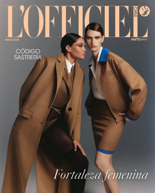 Two women in stylish tan outfits on a fashion magazine cover; the one on the left wears a long coat, the other a skirt and jacket.