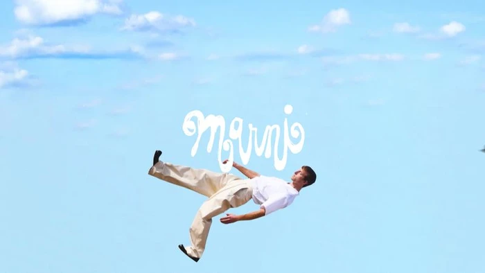 Man falling through a bright blue sky with white clouds for Marni SS25 Vol 2 campaign