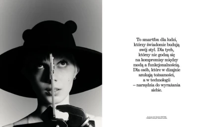 Model wearing a wide-brimmed black hat holding a smartphone vertically in front of her face, with editorial text on the white right page.
