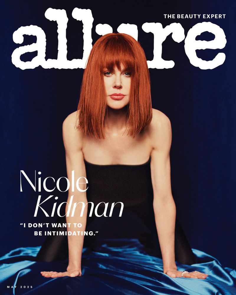 Magazine cover featuring Nicole Kidman with red hair, wearing a black top, and posing against a blue backdrop with Allure logo at top.