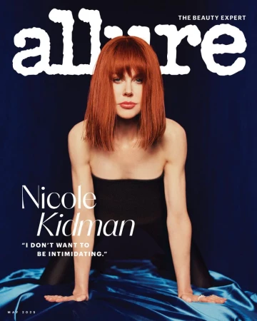 Magazine cover featuring Nicole Kidman with red hair, wearing a black top, and posing against a blue backdrop with Allure logo at top.