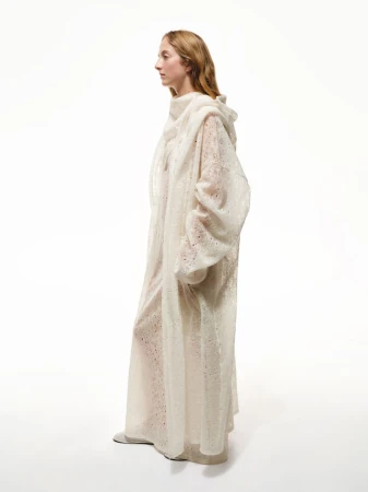 Woman in flowing hooded sheer white dress, side profile, full-length studio shot, clean background, fashion or bridal concept.