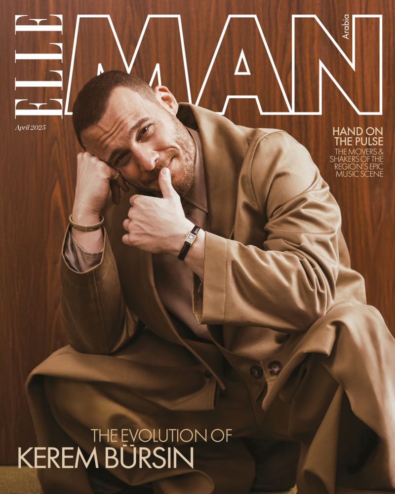 Magazine cover featuring Kerem Bursin in a beige suit, seated against a wood-paneled backdrop, Elle Man Arabia, April 2023 issue.