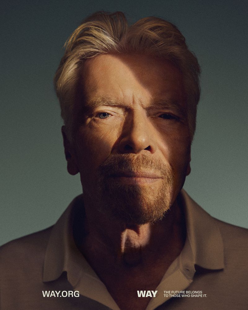 Close-up portrait of an adult man with light hair and a beard against a teal backdrop, featuring text overlay and dynamic lighting.