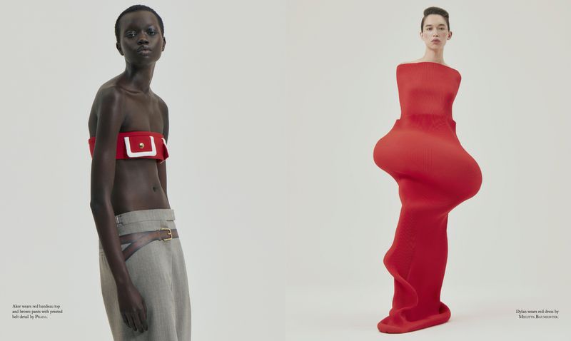 Two models pose in a studio: one in a red top and grey pants, the other in a form-fitting red dress against a clean, neutral backdrop.