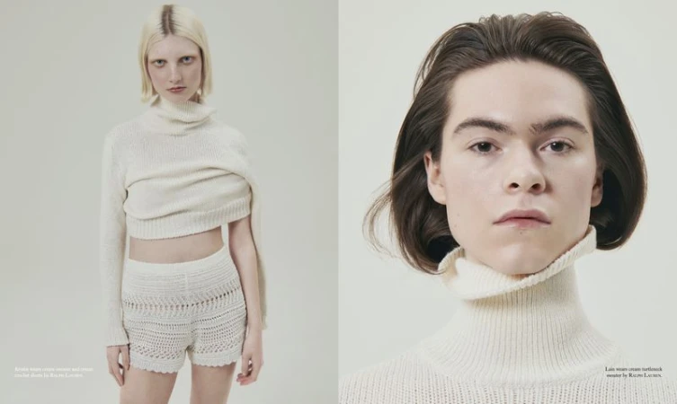 Two young adults in a studio shot, one blonde in knit shorts and crop sweater, the other with brown hair, wearing a turtleneck sweater.